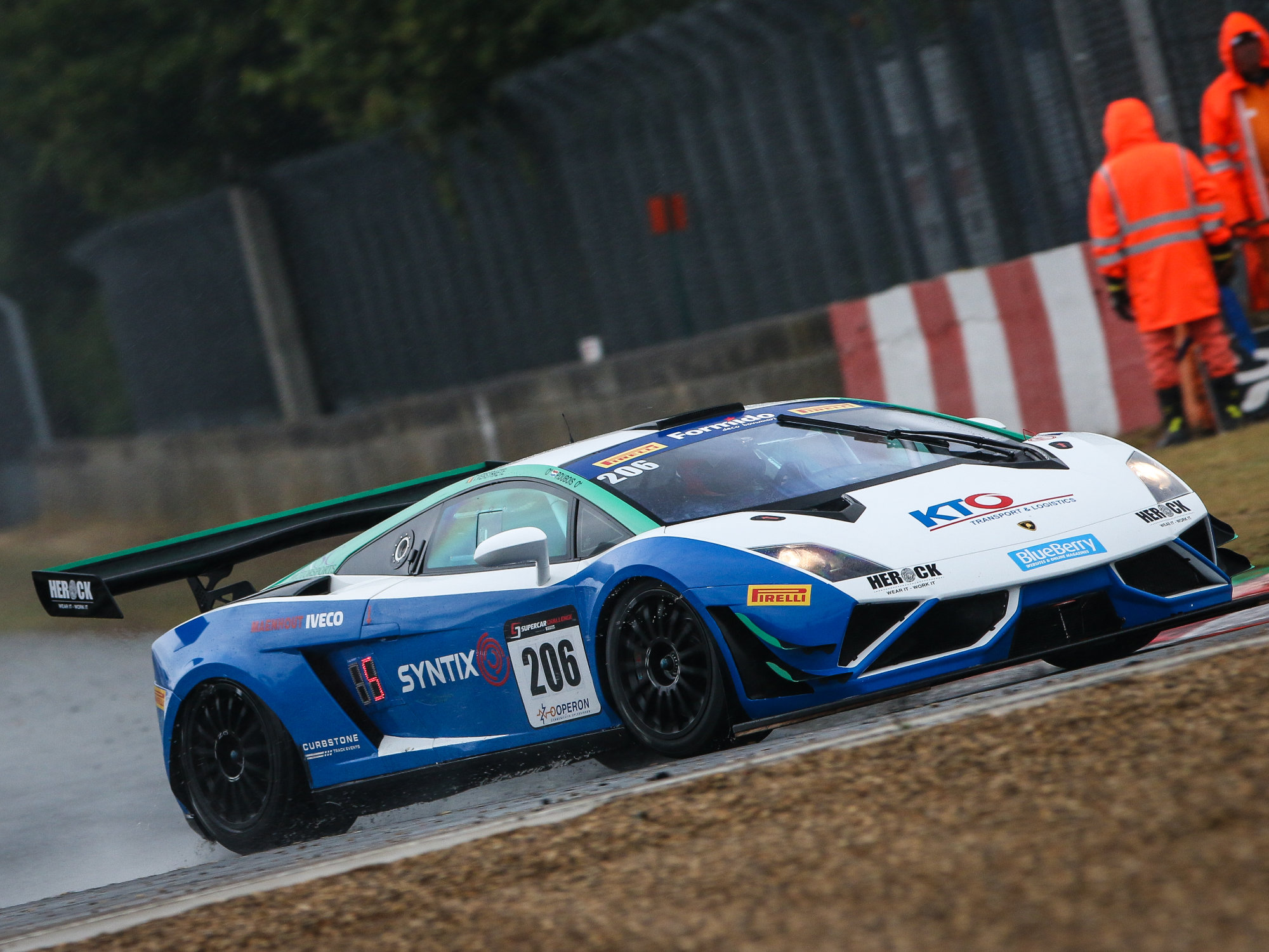 Race car wrapped in Syntix branding with logo and colors, captured on track