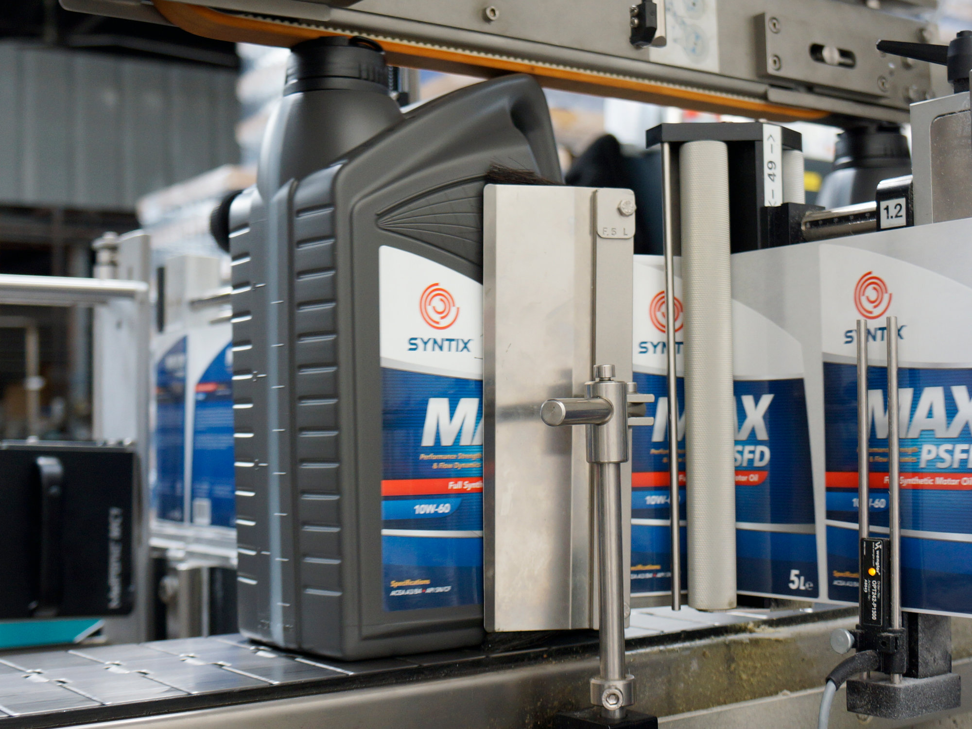 Syntix motor oil labels being printed and applied to bottles or boxes during packaging production