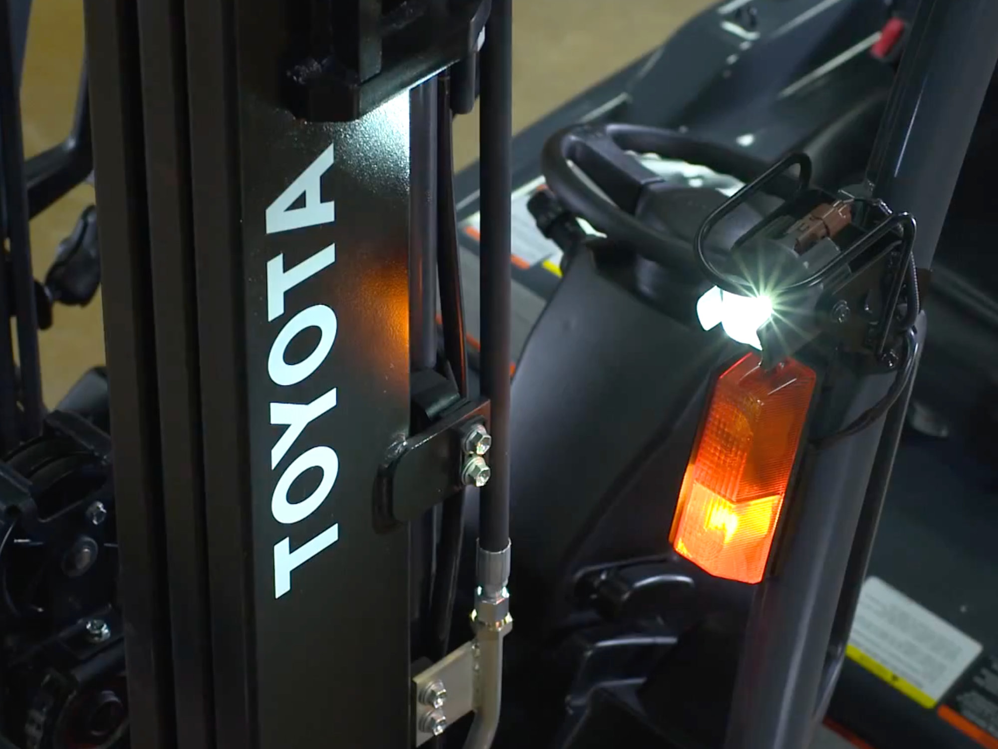 Close-up view of Toyota forklift showing safety lights and branding during industrial equipment motion graphics project