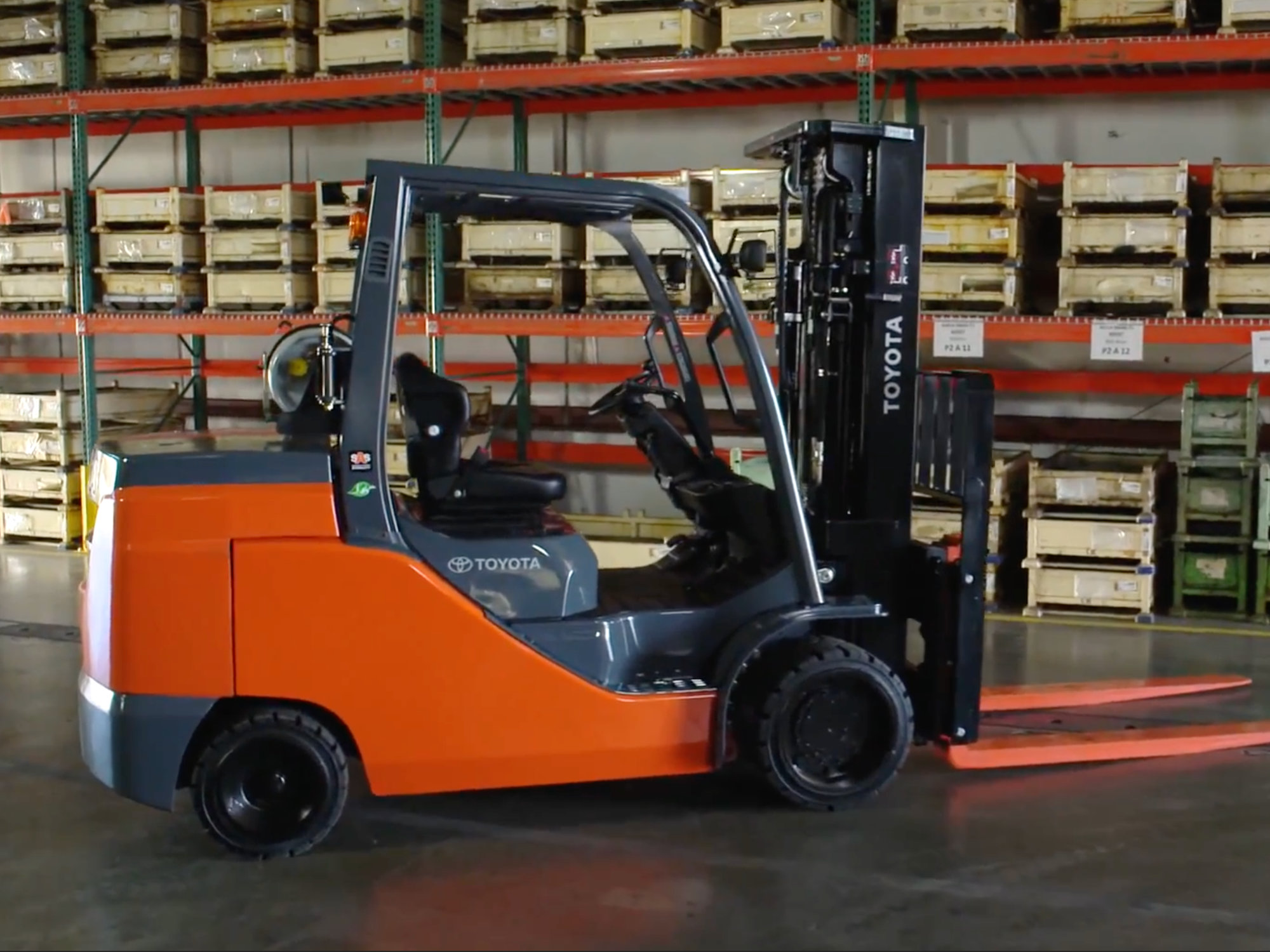 Toyota forklift operating inside a warehouse, representing industrial equipment efficiency and safety